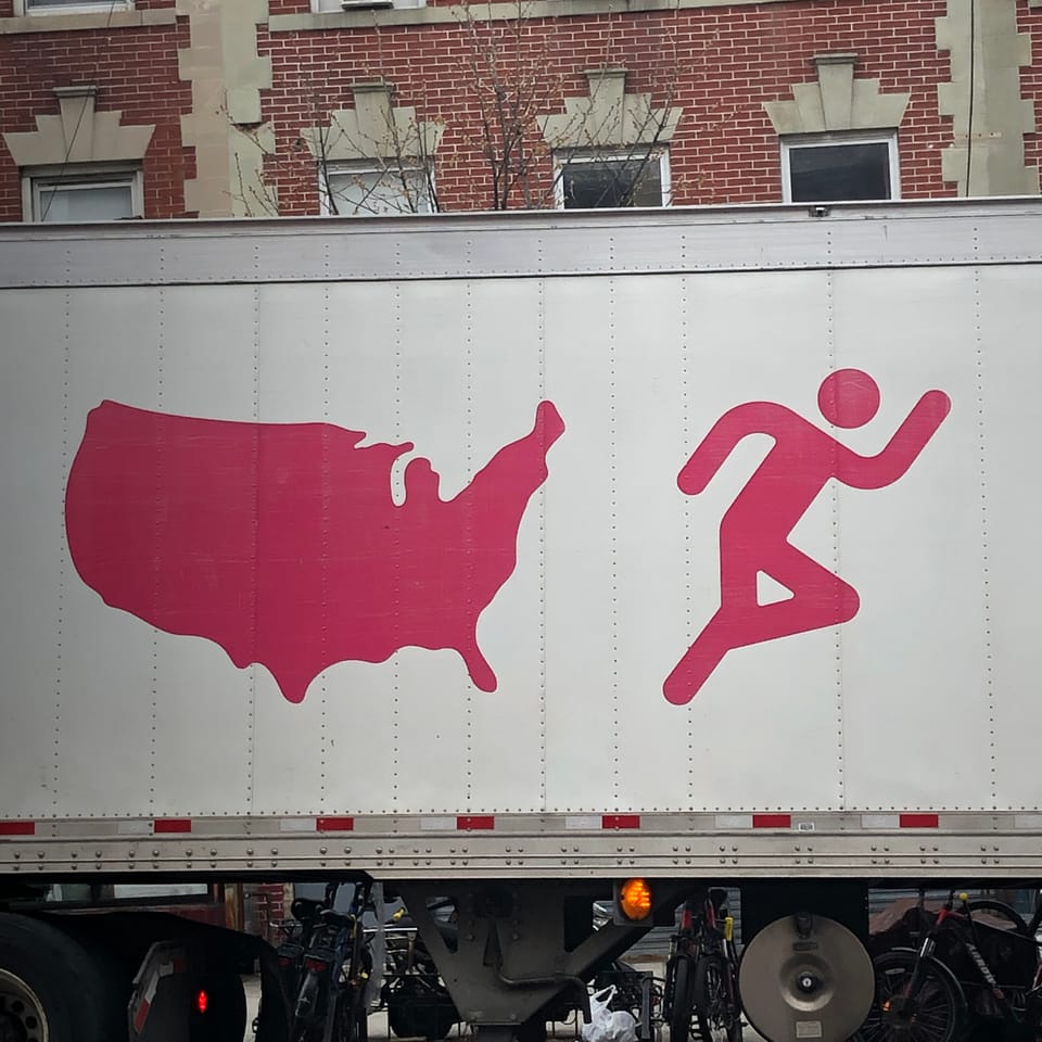 image on the side of a white truck: pink stick figure appears to be trying to escape the shape of the united states