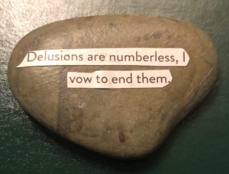 text on rock: Delusions are numberless, I vow to end them