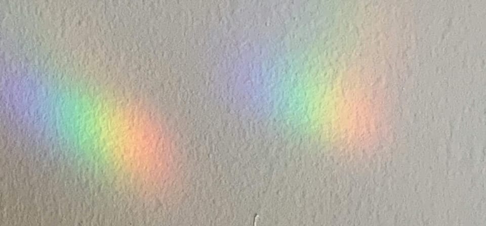 rainbow light reflected on a wall, image by J V